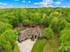 An aerial view of a luxurious home with meticulous landscaping and a circular driveway surrounded by lush greenery at 8451 Ridgewood Rd, Sherrills Ford, NC 28673