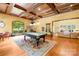 Spacious game room with a pool table, wood floors, custom lighting, and an adjacent living area at 8451 Ridgewood Rd, Sherrills Ford, NC 28673