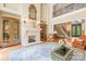 Elegant living room with a fireplace, high ceilings, hardwood floors, and ornate details at 8451 Ridgewood Rd, Sherrills Ford, NC 28673