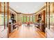 Spacious home office with custom wood built-ins, plenty of natural light, and beautiful hardwood floors at 8451 Ridgewood Rd, Sherrills Ford, NC 28673