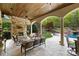 Spacious outdoor patio with stone fireplace, wood ceiling, TV and view of the pool at 8451 Ridgewood Rd, Sherrills Ford, NC 28673