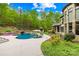 Inviting backyard with large pool, jacuzzi, tanning chairs, cabana, and lush landscaping at 8451 Ridgewood Rd, Sherrills Ford, NC 28673