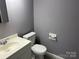 Practical bathroom featuring a white vanity, toilet, and neutral gray walls with tiled floors at 9325 Old Concord Rd # D, Charlotte, NC 28213