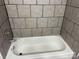 Clean white bathtub with light gray tile surround at 9325 Old Concord Rd # D, Charlotte, NC 28213