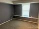Neutral bedroom features a window with natural light and neutral carpet at 9325 Old Concord Rd # D, Charlotte, NC 28213
