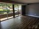 Open-concept living area with wood flooring and large sliding glass doors offering ample natural light at 9325 Old Concord Rd # D, Charlotte, NC 28213