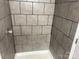 Shower with gray tiled walls, clean grout, and a clear shower head for a simple, functional design at 9325 Old Concord Rd # D, Charlotte, NC 28213