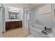 Bright bathroom offers a double sink vanity, shower, and luxurious soaking tub at 9437 Tavistock Ct, Matthews, NC 28105