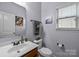 Powder room with modern sink, vanity, and lighting at 9437 Tavistock Ct, Matthews, NC 28105