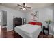 Comfortable bedroom with dark wood floor, ceiling fan, and artwork at 9437 Tavistock Ct, Matthews, NC 28105