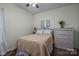 Cozy bedroom with warm carpeting, chest of drawers and charming bed frame at 9437 Tavistock Ct, Matthews, NC 28105