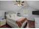 Cozy bedroom featuring a bed, ceiling fan, and a window providing natural light and ventilation at 9437 Tavistock Ct, Matthews, NC 28105