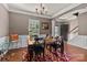 Well-lit dining area featuring a stylish rug, elegant furnishings, and crown molding at 9437 Tavistock Ct, Matthews, NC 28105