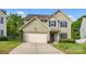 Charming two-story home featuring light green siding, black shutters, and a well-manicured front yard at 9437 Tavistock Ct, Matthews, NC 28105