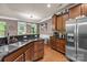 Spacious kitchen featuring stainless steel appliances, granite counters, and open dining area at 9437 Tavistock Ct, Matthews, NC 28105