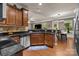Stylish kitchen featuring granite countertops, stainless steel appliances, and wood cabinetry at 9437 Tavistock Ct, Matthews, NC 28105