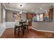 Eat-in kitchen features modern light fixture, stainless appliances and breakfast bar at 9437 Tavistock Ct, Matthews, NC 28105