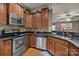 Well-equipped kitchen featuring stainless steel appliances, granite counters, and hardwood floors at 9437 Tavistock Ct, Matthews, NC 28105