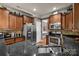 Modern kitchen boasts stainless appliances, granite countertops, and stylish cabinetry at 9437 Tavistock Ct, Matthews, NC 28105
