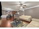 Open living room offers hardwood floors, view to kitchen and comfortable seating at 9437 Tavistock Ct, Matthews, NC 28105