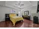 Spacious bedroom features a ceiling fan, dark wood floors, and bright, natural light at 9437 Tavistock Ct, Matthews, NC 28105
