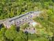 Aerial view of community featuring a swimming pool and ample parking at 1000 E Woodlawn Rd # 408, Charlotte, NC 28209