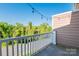 View from the balcony overlooking a quiet street lined with mature trees at 1000 E Woodlawn Rd # 408, Charlotte, NC 28209