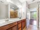 Bathroom with double vanity, large mirror, and shower/tub combination offers comfort and style at 1000 E Woodlawn Rd # 408, Charlotte, NC 28209
