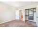 Bedroom with carpet with open doors showcasing bathroom and closet with built-ins at 1000 E Woodlawn Rd # 408, Charlotte, NC 28209