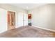 Bedroom with carpet with open doors showcasing bathroom and kitchen access for convenience at 1000 E Woodlawn Rd # 408, Charlotte, NC 28209