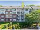 Apartment building with brick and siding, featuring multiple balconies on a sunny day at 1000 E Woodlawn Rd # 408, Charlotte, NC 28209