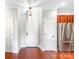 Welcoming foyer with hardwood floors, multiple doors, and stainless steel refrigerator at 1000 E Woodlawn Rd # 408, Charlotte, NC 28209