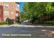 Private gated entrance to complex with parking area and well-maintained landscaping at 1000 E Woodlawn Rd # 408, Charlotte, NC 28209