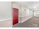 Hallway showing the front door to the unit; neutral colors throughout at 1000 E Woodlawn Rd # 408, Charlotte, NC 28209