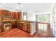 Open-concept kitchen with stainless steel appliances, dark cabinets, and a breakfast bar overlooking the living area at 1000 E Woodlawn Rd # 408, Charlotte, NC 28209