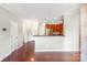 An open-concept kitchen with stainless steel appliances, wood cabinets, and bar seating at 1000 E Woodlawn Rd # 408, Charlotte, NC 28209