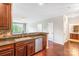 Well-appointed kitchen offering a view of the large living area with hardwood floors at 1000 E Woodlawn Rd # 408, Charlotte, NC 28209