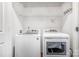 Laundry room with shelving and side-by-side, white, front-load washer and dryer at 1000 E Woodlawn Rd # 408, Charlotte, NC 28209