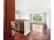 Open floorplan featuring stainless steel appliances, granite countertop, and large windows at 1000 E Woodlawn Rd # 408, Charlotte, NC 28209