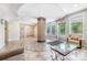 Well maintained lobby with tile floors, glass-top coffee table and comfortable seating at 1000 E Woodlawn Rd # 408, Charlotte, NC 28209