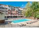 Community pool area with lounge chairs and lush landscaping, offering a relaxing outdoor space at 1000 E Woodlawn Rd # 408, Charlotte, NC 28209
