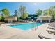 Inviting community pool area with lounge chairs, surrounded by lush greenery on a bright day at 1000 E Woodlawn Rd # 408, Charlotte, NC 28209