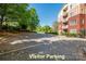 Close-up of visitor parking with condos in background, showing ample parking and well-kept grounds at 1000 E Woodlawn Rd # 408, Charlotte, NC 28209