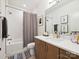 Well-lit bathroom featuring a shower-tub combo, vanity with cabinets, and neutral finishes at 1009 Belmont Ave, Charlotte, NC 28205