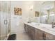Modern bathroom featuring double sink vanity, a large mirror, and glass shower at 1009 Belmont Ave, Charlotte, NC 28205