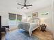 Comfortable bedroom featuring a metal bed frame, neutral decor, and natural light from multiple windows at 1009 Belmont Ave, Charlotte, NC 28205
