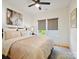 Cozy bedroom featuring a plush bed, neutral decor, a ceiling fan, and natural light at 1009 Belmont Ave, Charlotte, NC 28205