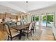 Bright dining area features modern chandelier, rug, and view of the backyard swimming pool at 1009 Belmont Ave, Charlotte, NC 28205