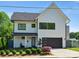 Attractive two-story home boasting a modern design with a sleek black garage door and well-maintained landscaping at 1009 Belmont Ave, Charlotte, NC 28205