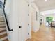 Bright hallway with hardwood floors, a staircase with black metal railing, and views into the dining area at 1009 Belmont Ave, Charlotte, NC 28205